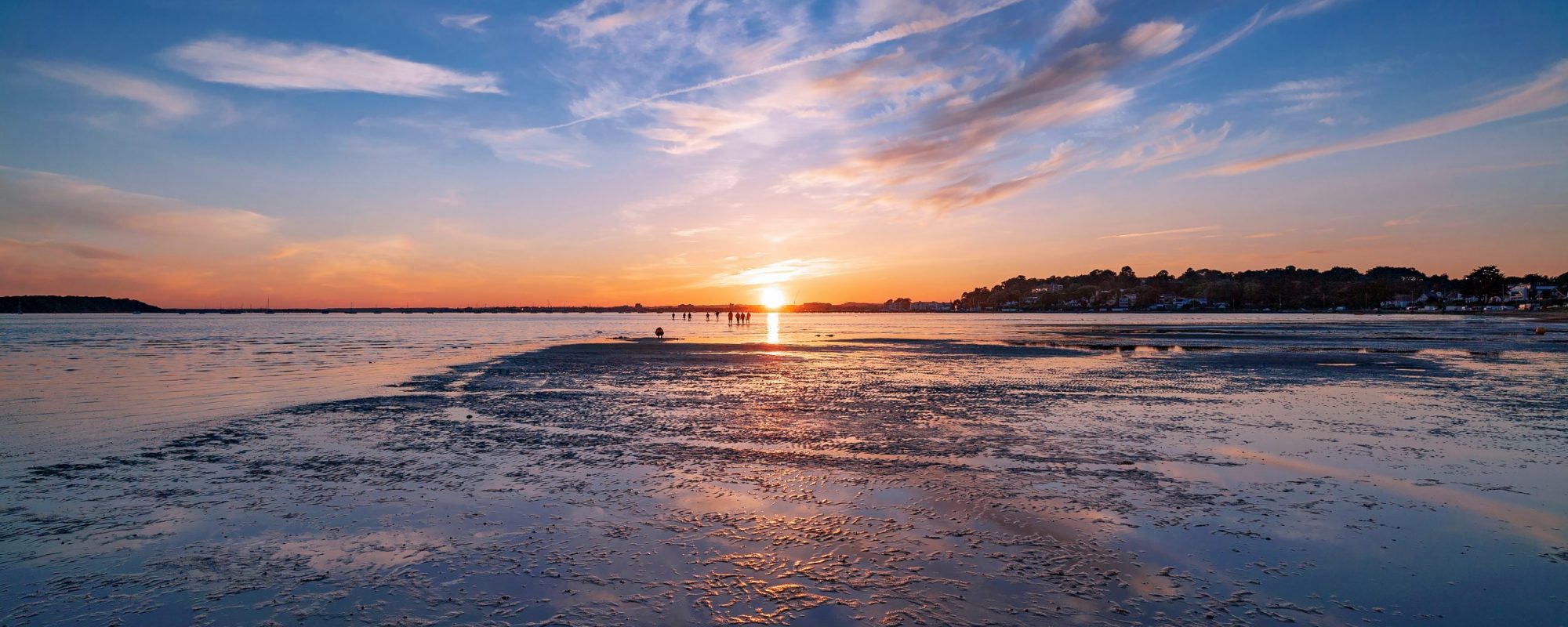 Vibrant sunset against a sunny sky over Poole Harbour in Dorset, UK