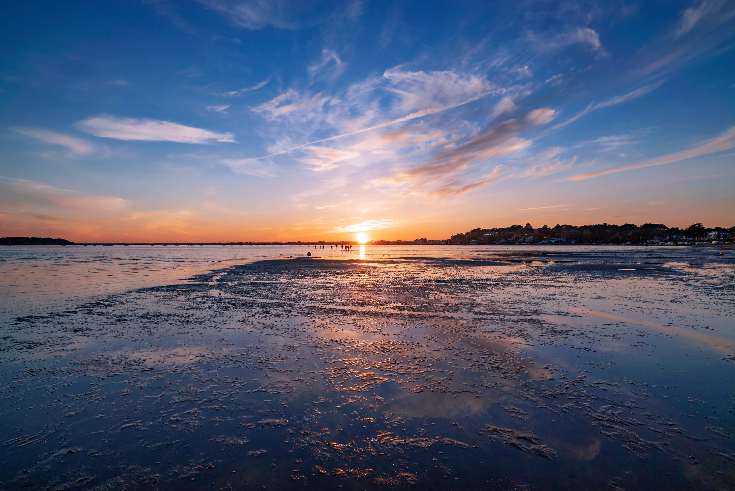Vibrant sunset against a sunny sky over Poole Harbour in Dorset, UK